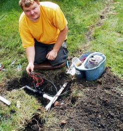 Irrigation contractor installs new sprinkler valves and wiring