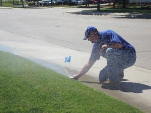 Mansfiend sprinkler repair specialist adjusts a poorly aligned Hunter pop-up head